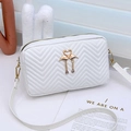 White quilted crossbody bag featuring wave embroidery and golden flamingo hardware - White