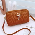 Caramel brown quilted PU leather crossbody bag featuring a golden flamingo heart charm - Brown