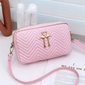 Pink quilted crossbody bag with golden flamingo ornament and V-shaped stitching detail - Pink