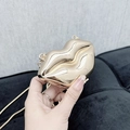 Modern gold lip-shaped hard shell clutch bag with metallic finish and thin chain strap - Lip Gold