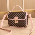 Brown handbag with clover print, pink leather trim, and gold hardware clasp - Pink Circle
