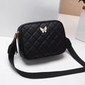 Black quilted crossbody bag with white butterfly metal charm and tassel detail - Black