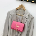 Rose pink woven crossbody bag with gold deer head lock and elegant tassel detail - Rose Red