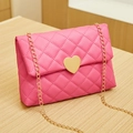 Pink quilted shoulder bag featuring a large gold heart buckle and chain strap - Rose Red