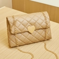 Quilted beige crossbody bag with heart-shaped gold clasp and elegant chain strap - Apricot