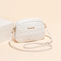 White quilted heart crossbody bag with gold logo and adjustable shoulder strap - White
