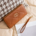 Brown long wallet with diamond quilting, gold-tone metal buckle, and matching wrist strap - Brown