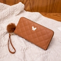 Quilted caramel brown long wallet with golden bow ornament and plush ball keychain charm - Brown