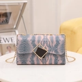 Pink and blue snakeskin crossbody bag with a gold chain strap and geometric clasp - Pink