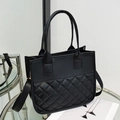 Chic black quilted tote bag with dual handles and adjustable shoulder strap for women - Black