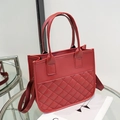 Red quilted faux leather tote bag with classic diamond stitching and wide fabric strap - Red