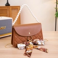 Brown quilted crossbody bag with pearl handle, metal chain, and stylish printed scarf accent - Brown
