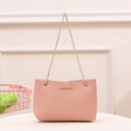 Pink quilted bucket bag with V-shaped stitching and a delicate gold chain strap - Pink