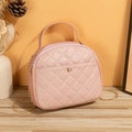 Pink quilted crossbody bag with golden chain and metallic buckle in minimalist setting - Pink