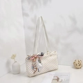 White pattern shoulder bag featuring a printed silk scarf handle in a bright minimalist setting - White