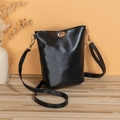 Minimalist black bucket bag with a gold twist lock and a sleek leather finish - Black