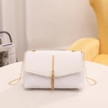 White quilted crossbody bag with gold chain strap and elegant metallic tassel - White