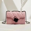 Chic pink quilted handbag with diamond stitching and gunmetal chain strap in a minimalist setting - Pink