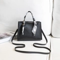 Minimalist black printed handbag with geometric scarf detail and matching shoulder strap - Black