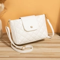 White quilted crossbody bucket bag with golden metal lock and leather shoulder strap - White