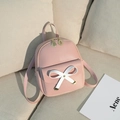 Mini sac à dos rose poudré en cuir synthétique avec un nœud blanc et zips dorés - Rose
