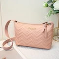 Elegant mauve pink shoulder bag with V-quilt pattern and gold logo on white background - Pink