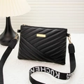 Black quilted crossbody bag featuring elegant gold hardware and letter printed strap - Black