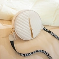 White round crossbody bag with V-quilted texture and gold tassel on fabric strap - White