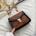 Women's flap crossbody bag with snakeskin pattern, black leather, and gold chain strap - Brown