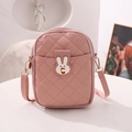 Pink quilted crossbody bag with rabbit hardware and adjustable strap on white pedestal - Pink