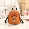 Mini quilted backpack in bright brown orange with stylish metal charms and black straps - Brown
