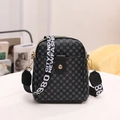 Classic black patterned crossbody bag with wide woven strap and gold circular buckle - Black