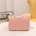 Pale pink quilted chain shoulder bag with a gold rectangular swivel lock closure - Pink