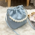 Light blue lychee texture bucket bag with elegant pearl handle and drawstring - Blue