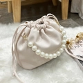 Creamy white litchi pattern bucket bag with elegant pearl handle and drawstring - White