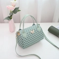 Mint green Boston style cylinder handbag with butterfly hardware and circular pattern - Blue