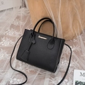 Classic black lychee pattern handbag with gold hardware logo and adjustable shoulder strap - Black