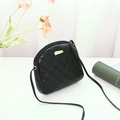 Elegant black quilted shell cross-body bag with golden geometric hardware accents - Black