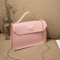 Elegant mini soft pink leather crossbody bag featuring a gold chain and butterfly clasp - Pink