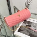 Pink quilted cylinder crossbody bag with V-shaped stitching and golden chain strap - Pink