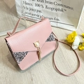 Pink pebbled leather shoulder bag with zebra print trim and gold pearl tassel clasp - Pink