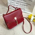 Red lizard embossed handbag featuring zebra print sides and a cat pearl magnetic buckle - Red