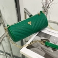 Vibrant green cylinder bag in glossy faux leather with V-quilt pattern and gold tree charm - Green