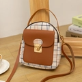 Mini plaid backpack with brown leather straps and vintage gold buckle in a warm setting - Brown