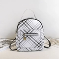 Stylish white mini backpack with black grid pattern and golden circular zipper pendant - Off White
