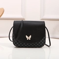 Black leather shell bag with white butterfly buckle and grey clover print detail - Black