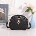Black quilted crossbody shell bag with golden mouse clasp and star pendant detail - Black