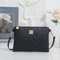 Black quilted crossbody bag with gold metal plate and adjustable strap for women - Black