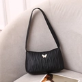 Quilted black shoulder bag for women with golden butterfly charm and pleated faux leather - Black