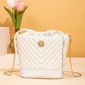Modern white quilted bucket bag with golden chain strap and circular metal logo - White